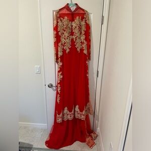 Red traditional Vietnamese wedding dress ao dai with gold beads and appliqués